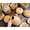 This shows several unfinished gourds along side some gourds made into decorative vases.
